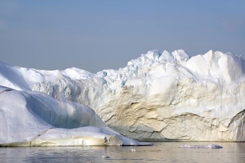 Giant iceberg in the glow of the midnight sun Disko Bay, Ilulissat, Arctic, Greenland, Denmark,