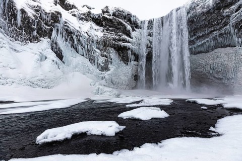 Skogafoss waterfall, snowy and icy rock face, Sudurland, Iceland, Europe