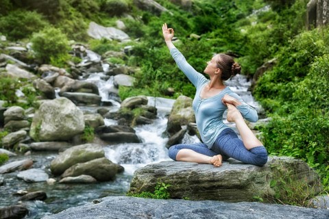 Young sporty fit woman doing yoga asana Eka pada rajakapotasana, one-legged king pigeon pose at