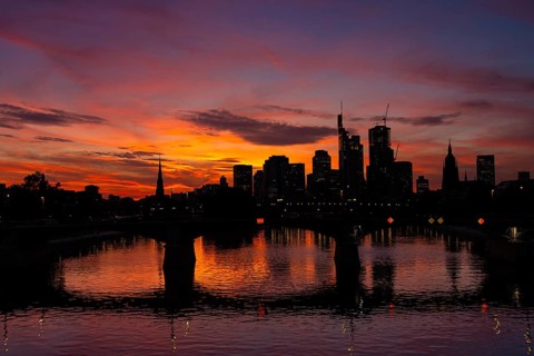 The silhouette of Frankfurt's banking skyline stands out against the luminous evening sky in the