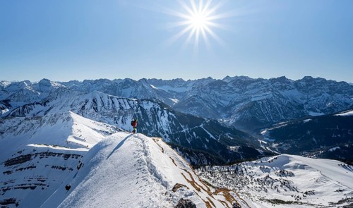 Ski tourers at the summit of Schafreuter, view of snowy mountain panorama, Sonnenstern, Karwendel,