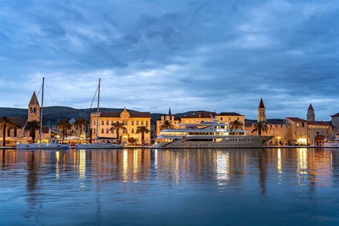 Cruise ship in front of the old town centre of Trogir at dusk, Croatia, Europe