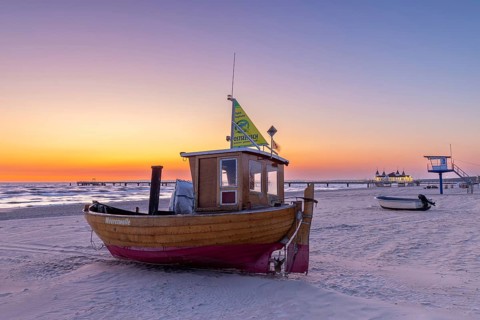 Traditional wooden fishing boat on the beach along the Baltic Sea at Ahlbeck, Heringsdorf on the