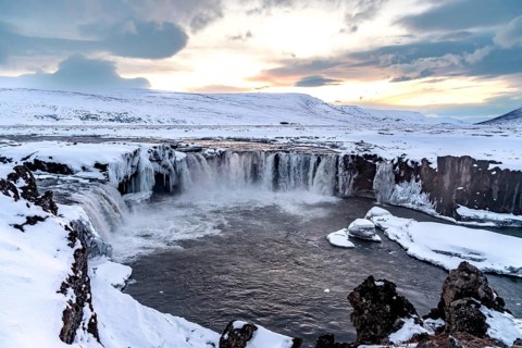 Beautiful landscape at Godafoss waterfall at sunset in winter, Iceland, Europe