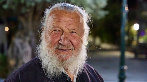 Papas Vaianos, Pope in Psinthos, An elderly man with a white beard smiles outdoors at night, Easter