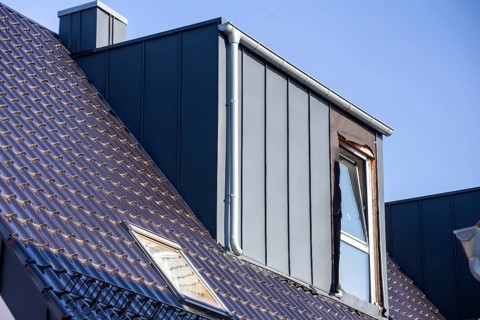 Extension of living space by installing a dormer window: Newly installed dormer window on a newly