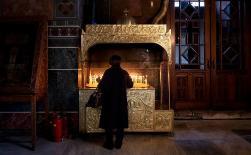 Woman offering a candle, from behind, interior view of Hagia Sofia church, also Agia Sofia, dome,