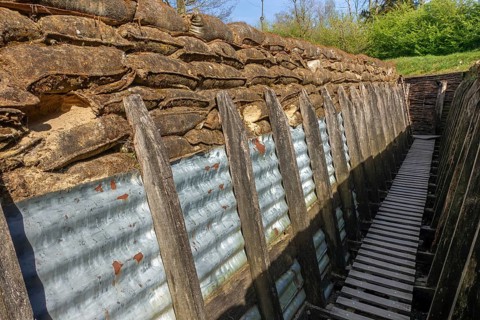 British WW1 trench showing wooden duckboards on A frames, sandbags and sheets of corrugated iron at