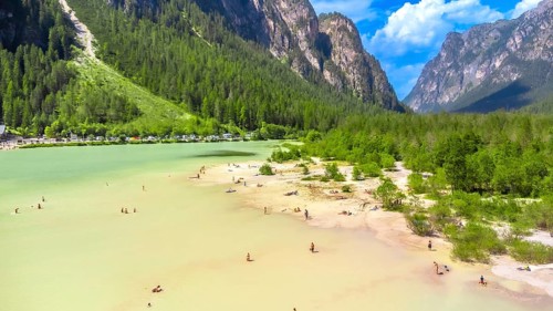 Tourists enjoying summer at lago di landro, also known as durrensee lake, surrounded by the