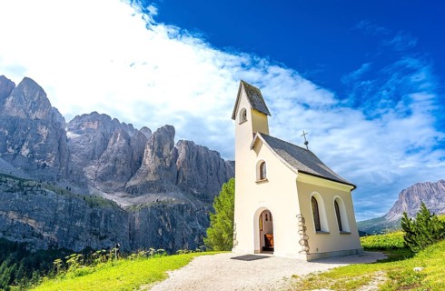 Scenic view of a charming church nestled in the italian dolomites, with the breathtaking peaks