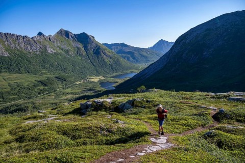 Mountaineers on a hiking trail to the summit of Rundfjellet, mountain landscape and valley with