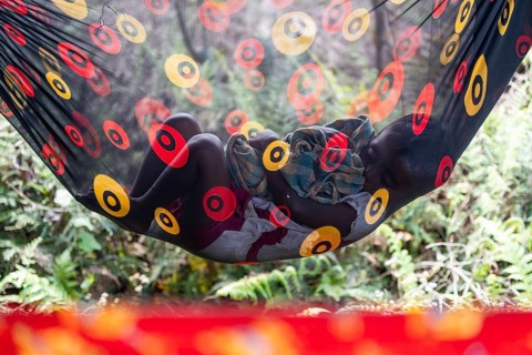 A child of tea plantation worker underneath a tent as mothers pluck tea leaves at the Tea Estate on