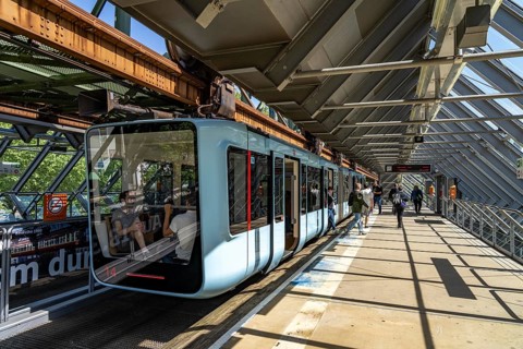 The Wuppertal suspension railway, train of the latest generation 15, floats above the Wupper,