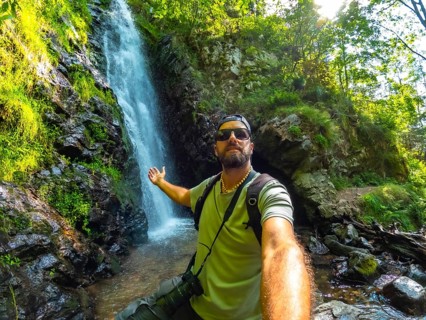 Man tourist hiker in summer at Todtnau waterfall in Black Forest in Germany