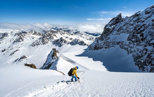 Mountaineer with ice axe and crampons, ascent through steep snowfield to Piz Kesch or Piz d'Es-cha