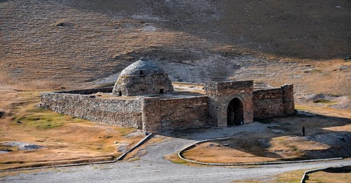 Historic caravanserai Tash Rabat from the 15th century, with yellow hills, Atbashy district in the