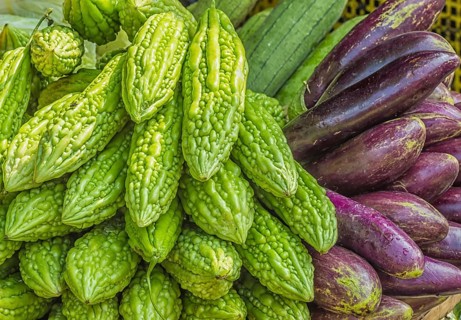 Fresh eggplant and momordica on the market