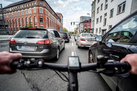 Cycling in the city, city centre road, no cycle lane, two-lane traffic in both directions,