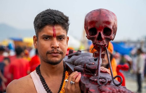 A Hindu priest arrives awith a human skull on the bank of Brahmaputra river on Ashoka Ashtami