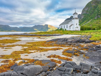Gimsøy church with beach and seaweed, Gimsøy, Lofoten, Norway, Europe