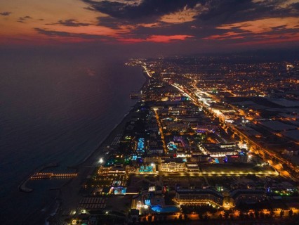 The lights of the tourist accommodations on the Turkish Riviera near Alanya glow colourfully in the
