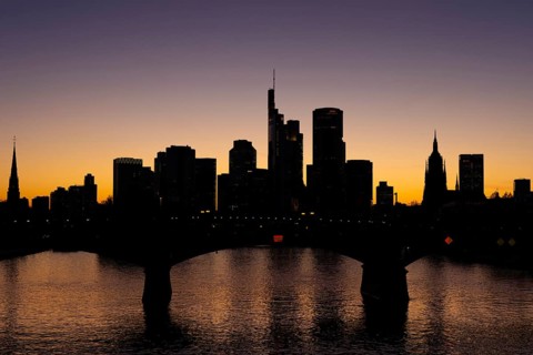 The silhouette of Frankfurt's banking skyline stands out in the evening against the residual light