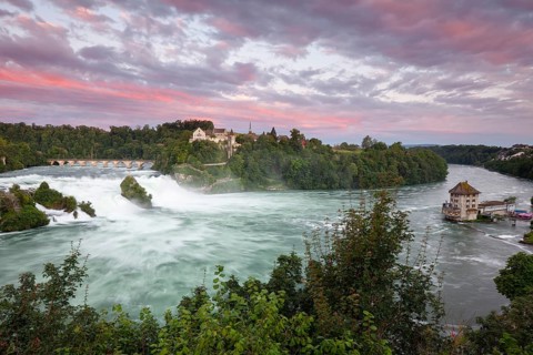 The Rhine Falls at Schaffhausen in Switzerland at sunset with Laufen Castle on the Rhine Falls. An