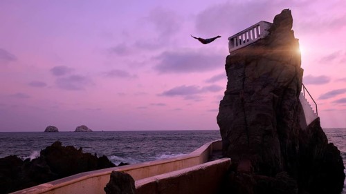 Mexico, Mazatlan El Clavadista cliff drivers diving on Malecon to entertain tourists, Central