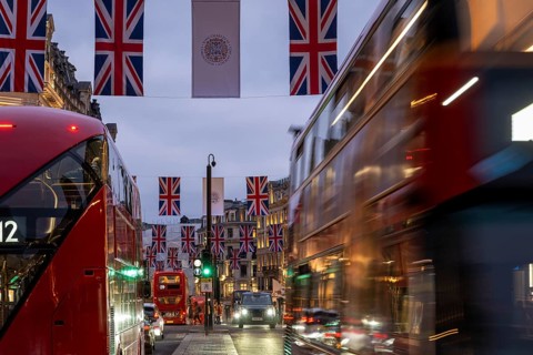 Red double-decker buses, English flags, evening mood, Oxford Circus, London, London region,