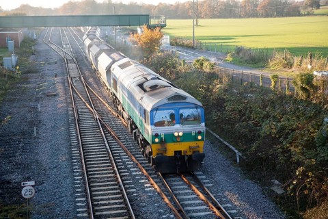 Diesel locomotive freight train on the West Coast mainline at Woodborough, Wiltshire, England, UK