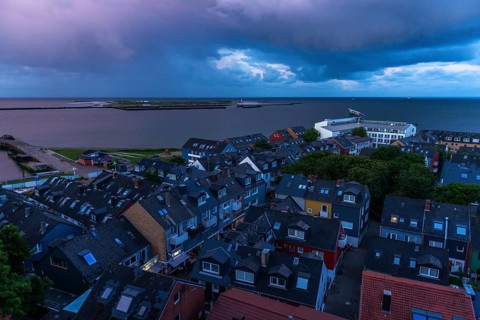 View from the upper land over the houses in the lower land to the Helgoland dune, Helgoland island,
