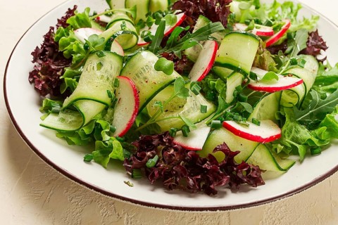 Vegetable salad, radishes and cucumbers, radish micro-greens, lettuce leaves, green onions,