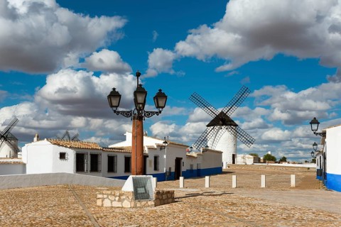 Street lamp and windmill in a picturesque village with white houses and cobbled streets, windmills