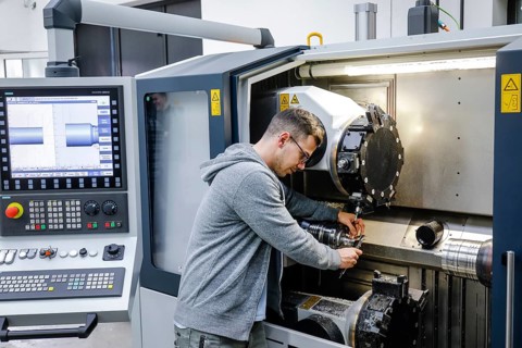 Remscheid, North Rhine-Westphalia, Germany - Trainee in metalworking, here at a CNC machine tool,