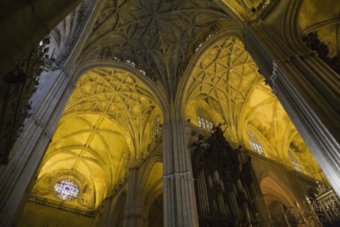 Architectural details on ceiling and stained glass rose window in Interior of The Cathedral of