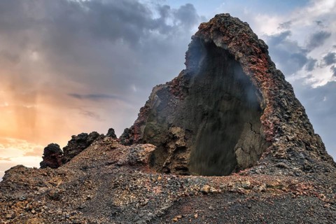 Cave, smoke, volcanic landscape of the Fire Mountains, Montañas del Fuego, Timanfaya National Park,