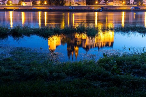 Reflection of Bischofsburg, Albrechtsburg and cathedral in the water of the Elbe at blue hour,