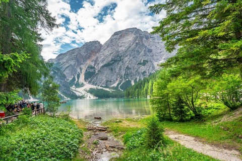 Tourists enjoying the landscape at lake braies, also called pragser wildsee, with the seekofel
