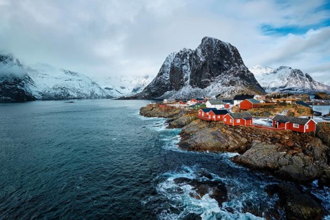 Hamnoy fishing village with red rorbu houses in Norwegian fjord in winter. Lofoten Islands, Norway,