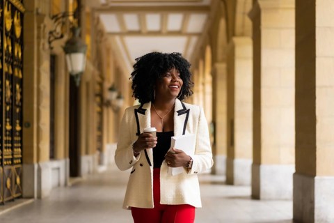 Elegant african american businesswoman walking in the city street in the morning