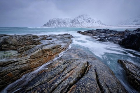 Waves and rocks on coast of Norwegian sea in fjord. Skagsanden beach, Flakstad, Lofoten islands,