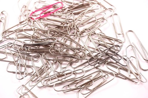 Detail of paper clips on a white background, copy and paste space