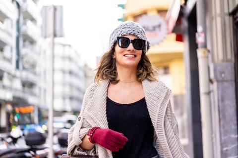 Lifestyle, young Caucasian blonde girl enjoying and smiling in the city in winter. Strolling with