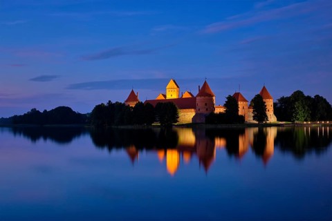 Evening view of Trakai Island Castle in lake Galve illuminated in the night, Lithuania, Europe