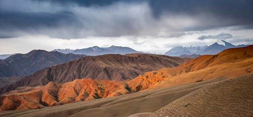 View over eroded mountainous landscape of Konorchek Canyon with red sandstone cliffs, high