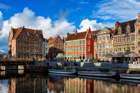 Ghent canal Graslei and Hooiaard streets with tourist boats on sunset. Ghent, Belgium, Europe