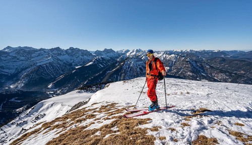 Ski tourers at the summit of Schafreuter, view of snowy mountain panorama, Karwendel, Tyrol,