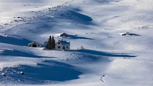 Farmhouse in snow-covered hilly landscape, near Akureyri, North Iceland Eyestra, Iceland, Europe