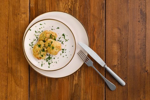 Top view of veal cutlets baked in oven on a plate