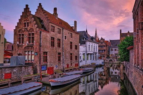 Bruges Rozenhoedkaai old houses along canal with tree in the evening. Famous place of Brugge,